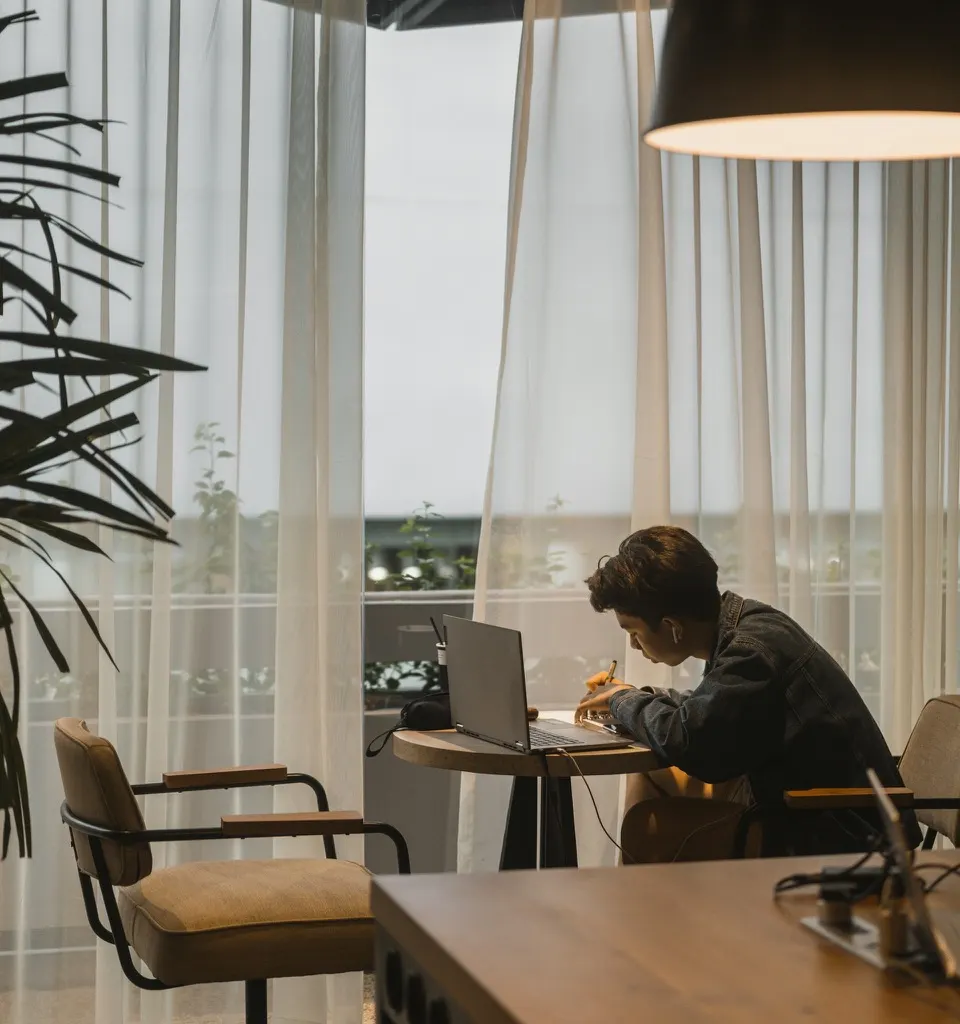 A founder reviewing financial paperwork at a kitchen table